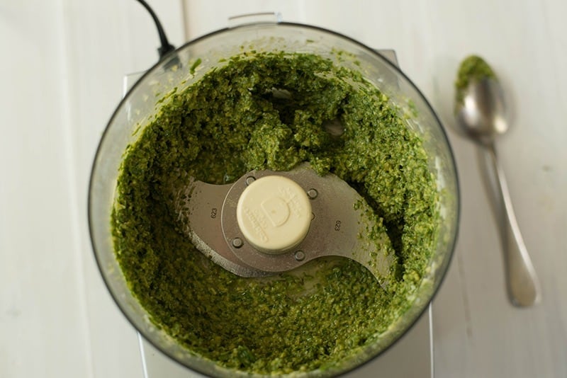 Overhead view of the food processor containing ready to serve pesto sauce.