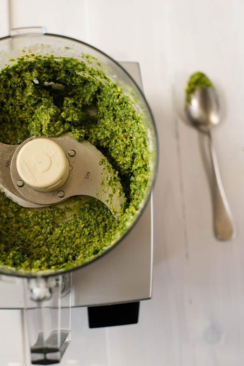 Overhead view of the food processor containing pesto sauce, processed and ready to serve.