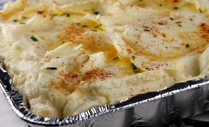 Creamy Oven Baked Mashed Potatoes in a foil pan just out of the oven