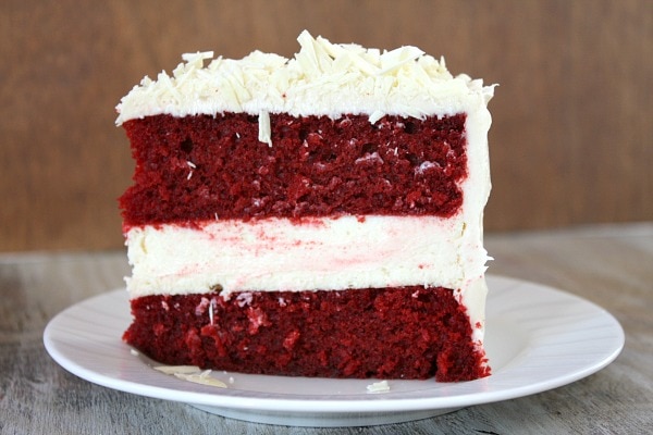 slice of red velvet cheesecake cake on a white plate