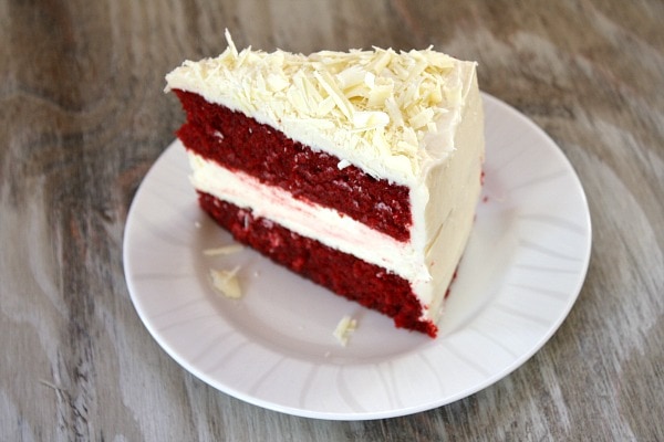 slice of red velvet cheesecake cake on a white plate