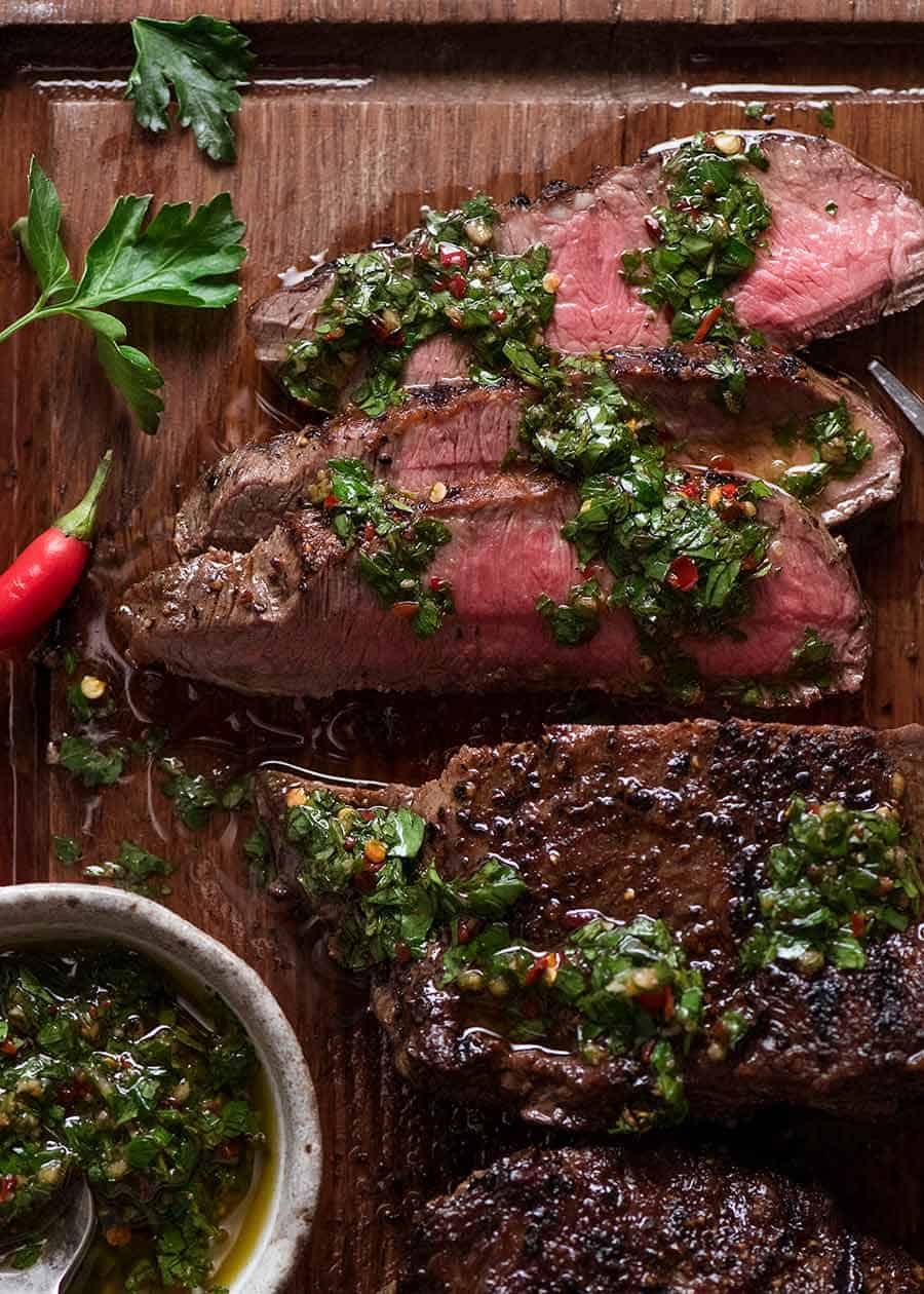Overhead photo of Chimichurri Steak on a cutting board, ready to be served